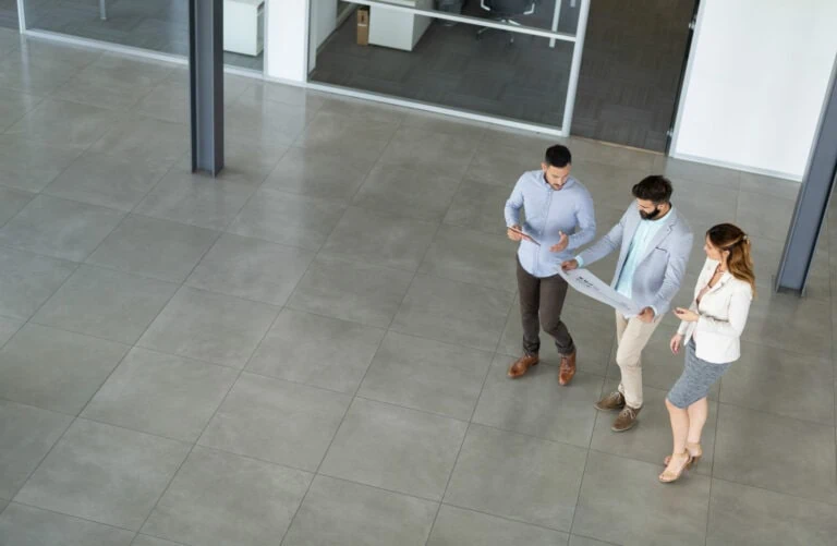 overhead look at group of 3 business people looking at document