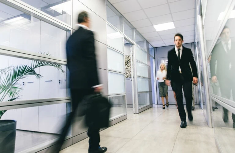 abstract business people walking in hallway blurred out