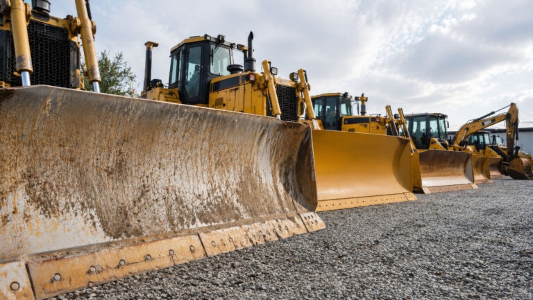 lineup of yellow bulldozers